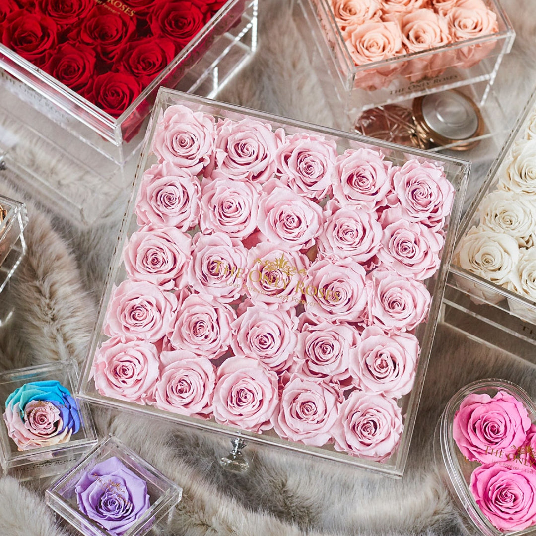 Boxes of colorful preserved roses on display